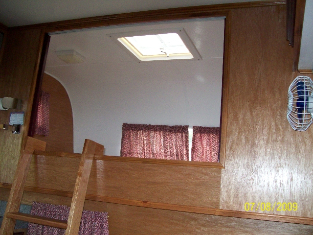 Photo of the bedroom of the old camper after it was renovated.