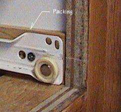 Photo of packing behind a drawer slide.
