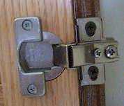 Photo of the hinge on a face frame cabinet.