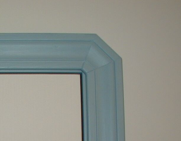 Photo of the mitre in the corner of a  window casing.