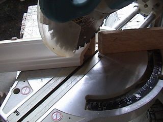Photo of a miter saw cutting an inside miter on molding.