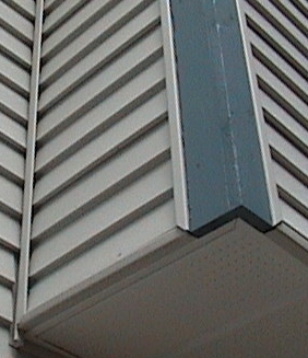 Photo of inside corner trim on an exterior wall with vinyl siding