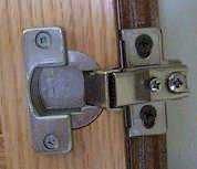 Photo of the hinge on a face frame cabinet.
